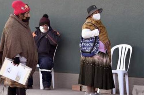 Indígenas bolivianas esperan afuera de un banco en El Alto. Foto Afp